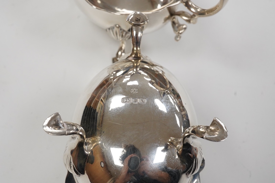 A pair of George VI silver sauce boats, with flying scroll handles, by C.J. Vander Ltd, London, 1948, length 14.3cm, 11oz.